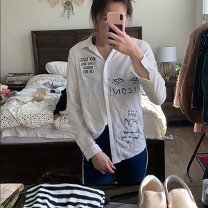 White shirt with embroidered phrases